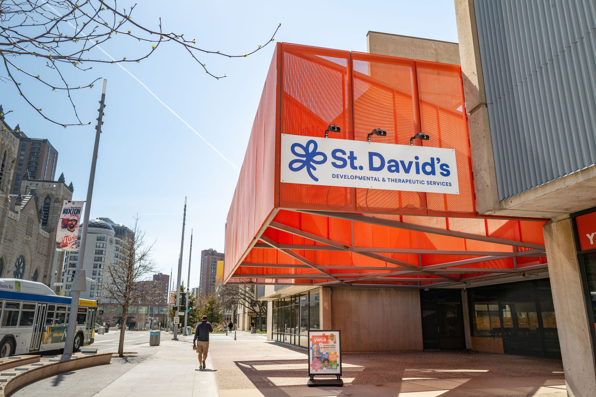 exterior of downtown nicollet center building - a concrete and glass square-ish structure with an orange awning.