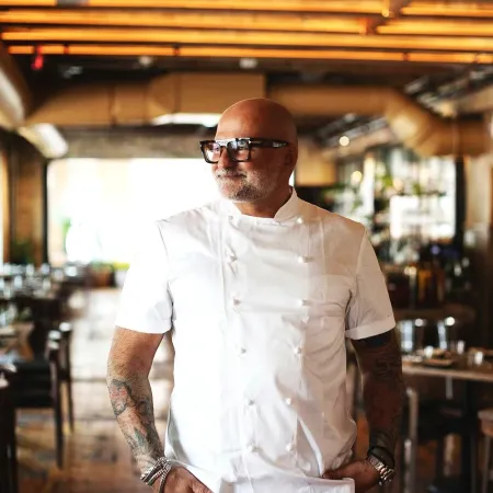 chef with tattoos standing in his restaurant