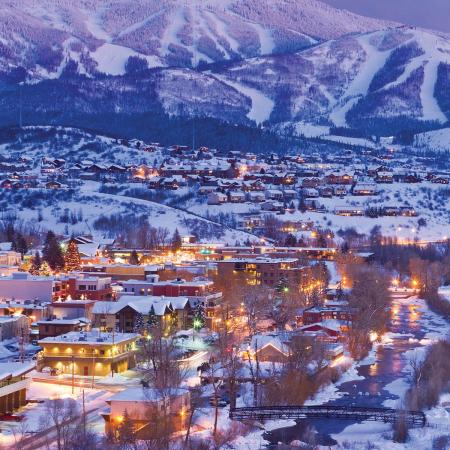 aerial view of ski town with snowy mountains in the distance