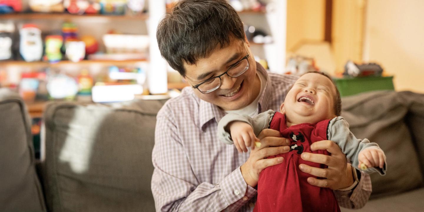 Man and baby laughing
