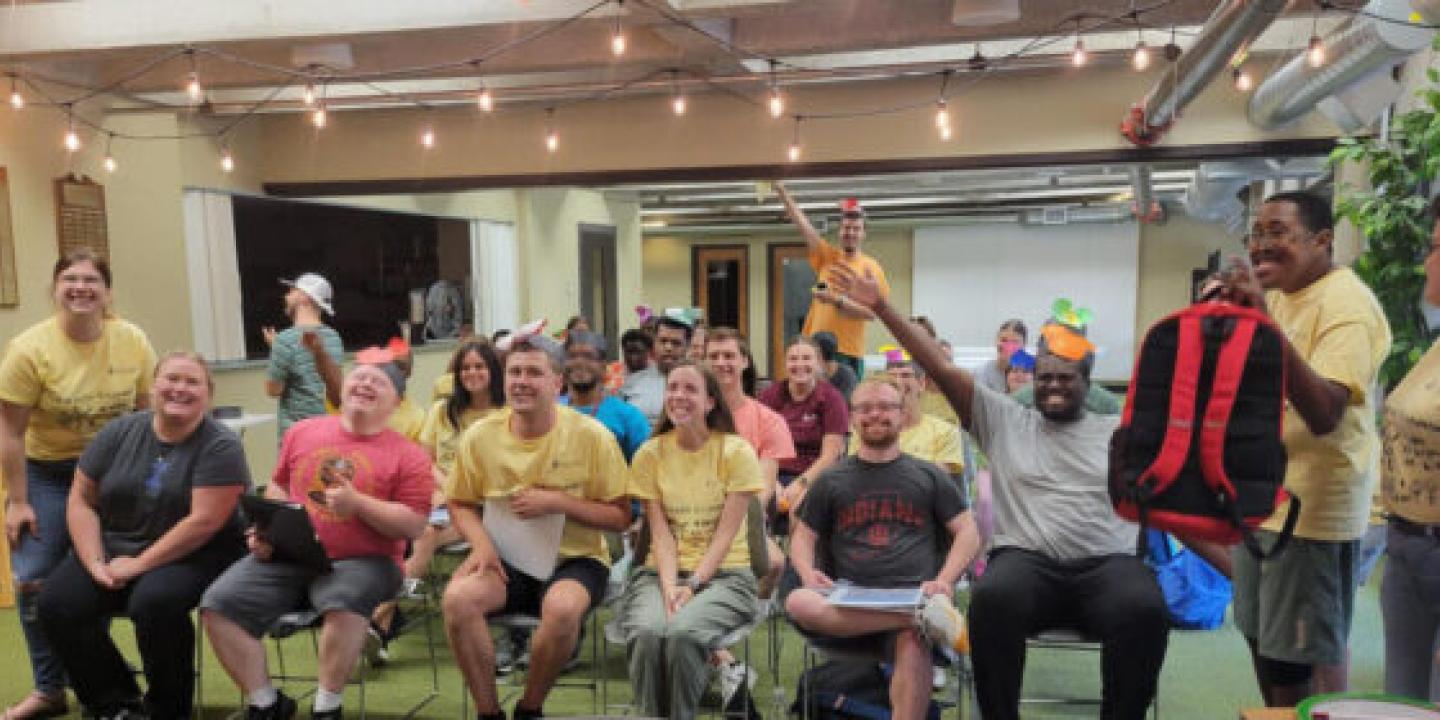 A group of smiling people in a conference room