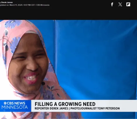 An image still of a news broadcast with a woman smiling