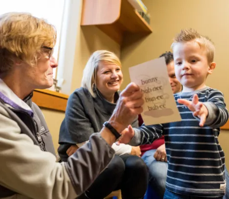 People handing a child paper