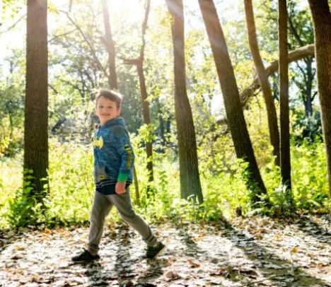 A child walking through the woods