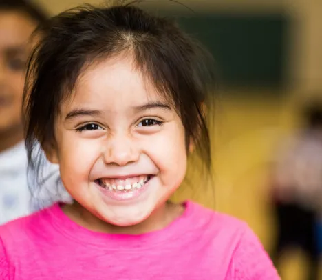 A child smilling at the camera