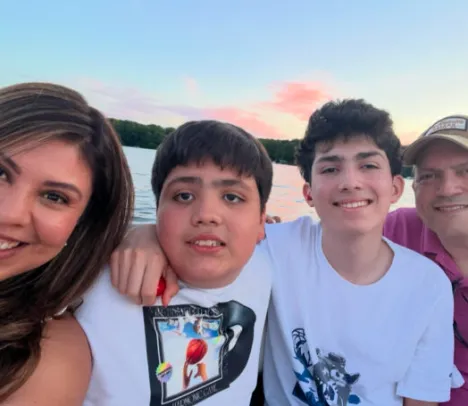 A family on a boat smiling at the camera