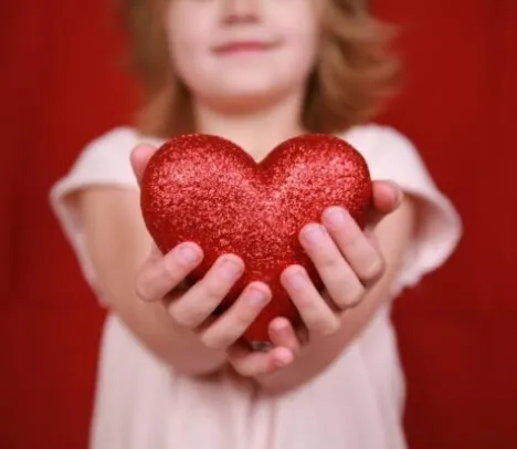 A child holding a heart shaped object