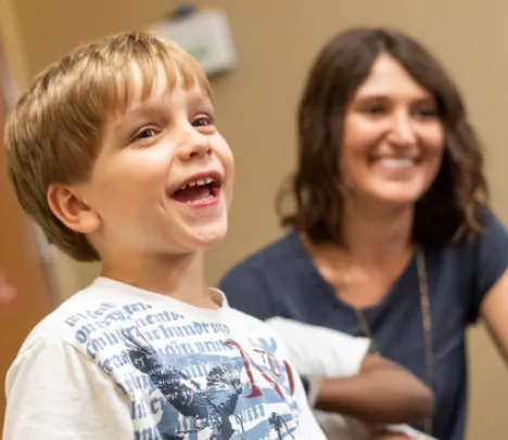 A child and mother smiling