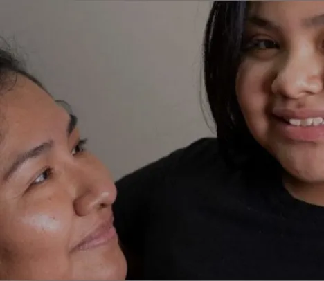 A child and parent smiling