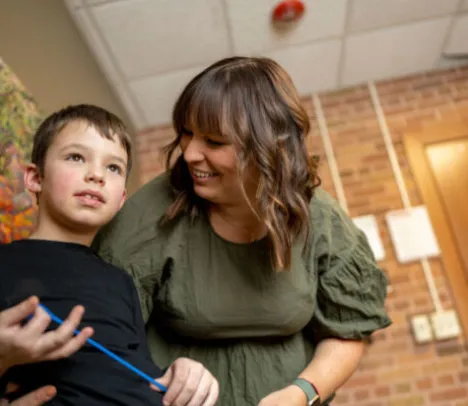 A woman helping a child