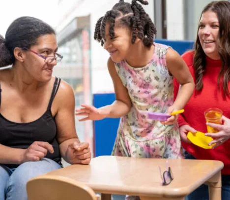 Two adults and a smiling child