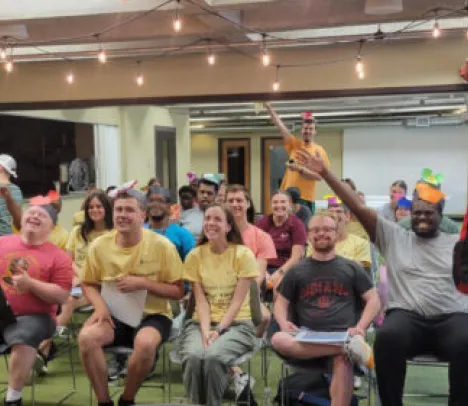 A group of smiling people in a conference room