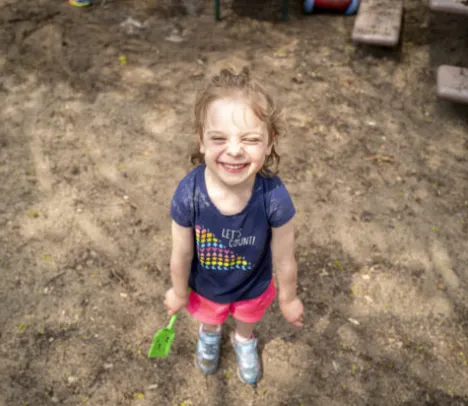 A child smiling in the sun