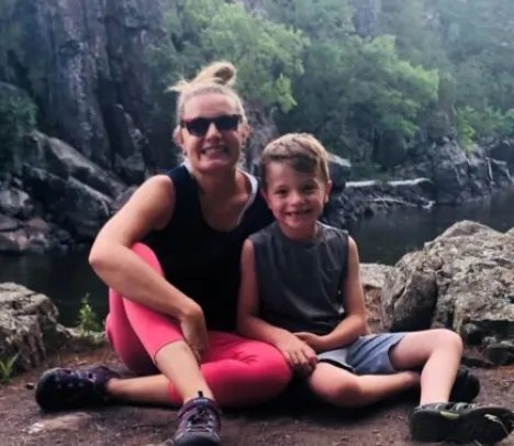 A mother and son smiling