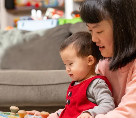 Asian mother holding her young daughter