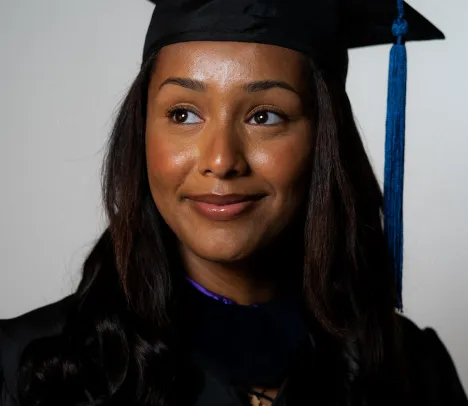 new grad bemnet habtamu smiles for the camera in her graduation gown