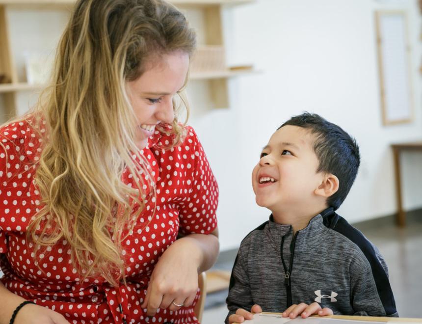 A woman and child smiling at each other