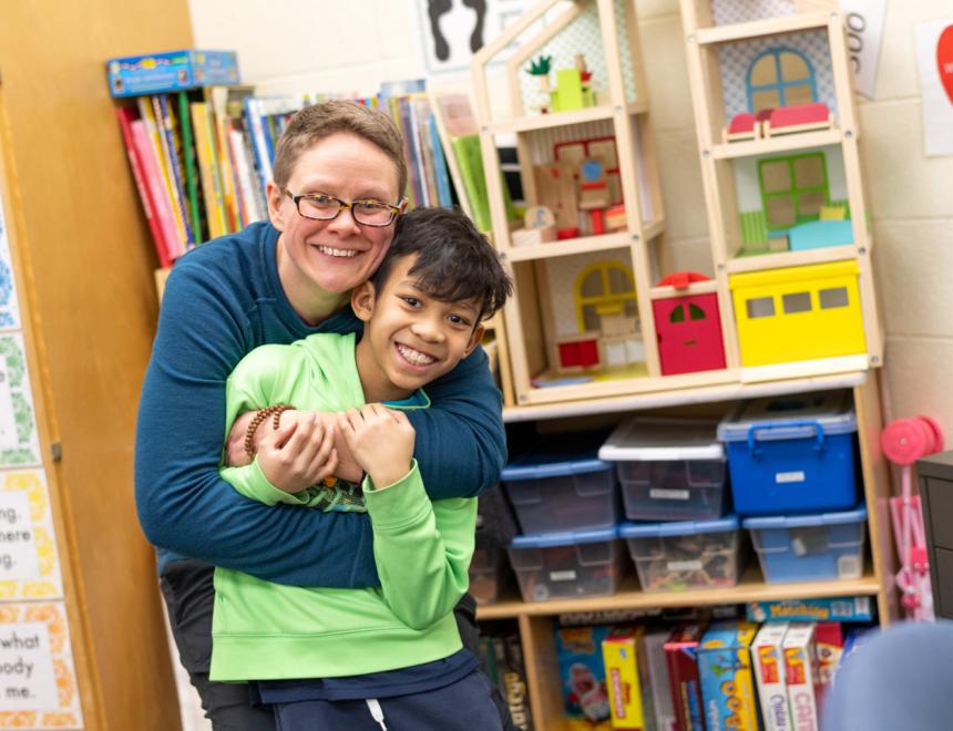 A parent hugging a child