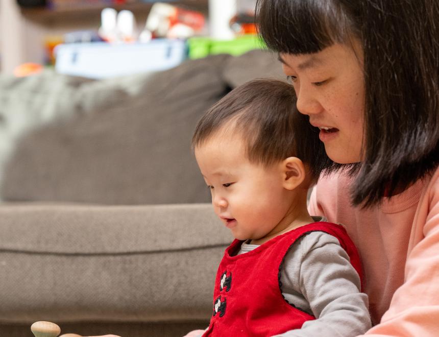 Asian mother holding her young daughter