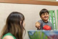 A child pointing and smiling