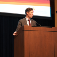 A person giving a presentation at a conference