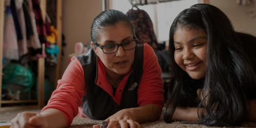 And adult and child working on a project together
