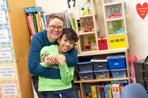 A parent hugging a child