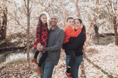 family of dad mom, two kids, boy and girl multiracial