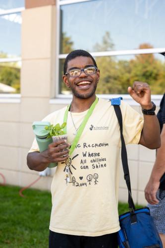 Therapeutic Rec adult attends the Get Out and Grow event.