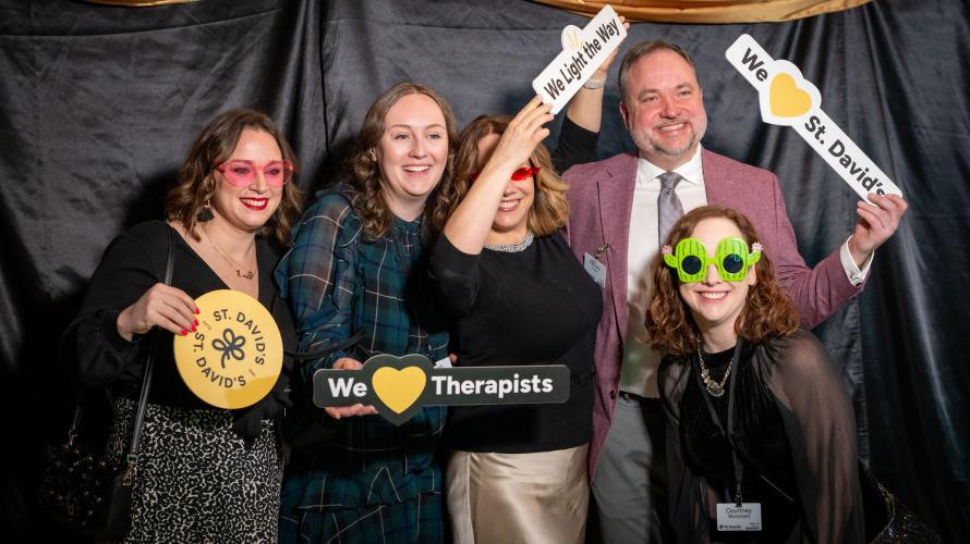 Group of people at photo op at gala. 