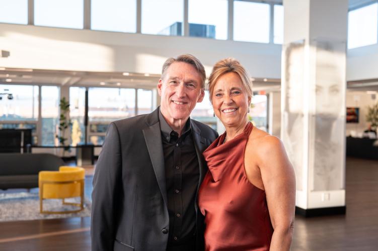 Man and woman in lobby of gala event.