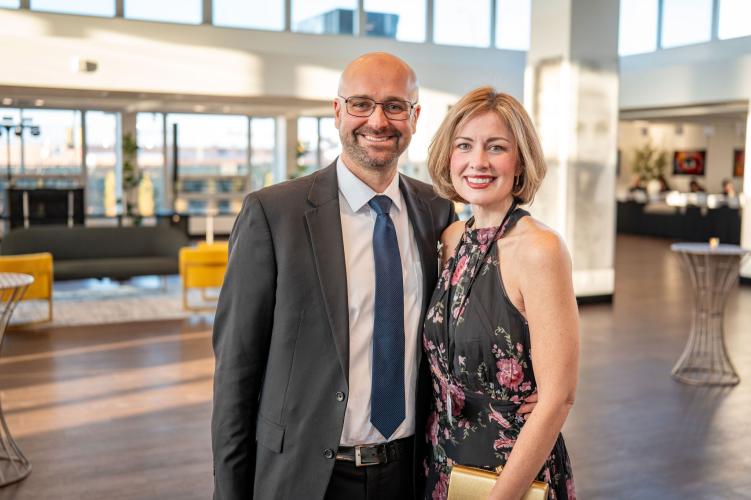 Portrait of a man and woman in lobby of gala event. 