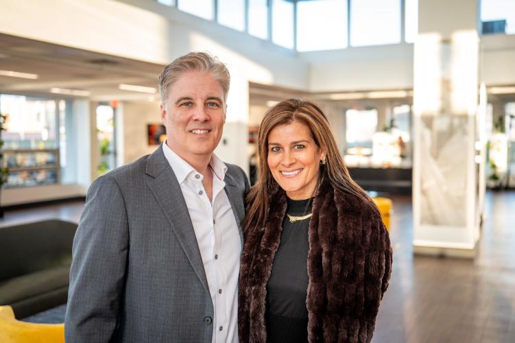 Portrait of man and woman in lobby of gala event.