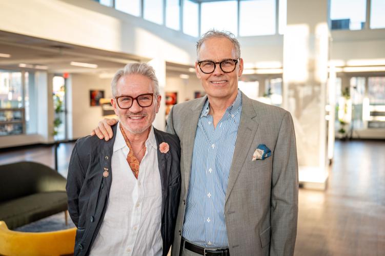 Portrait of man and woman in lobby of gala event. 