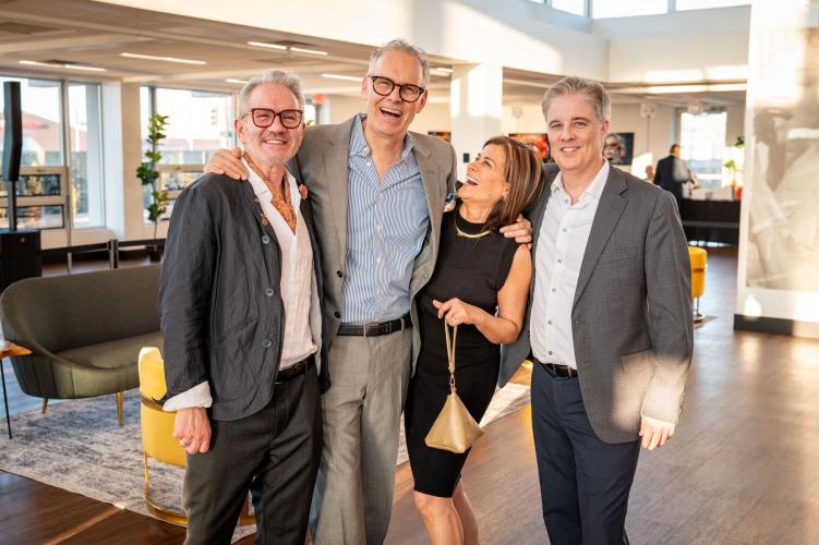 Group of people laughing and smiling at the camera.