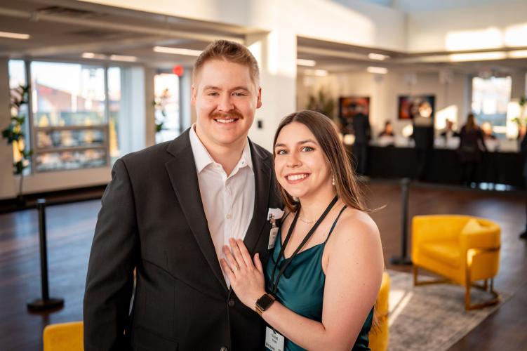 Man and woman in lobby of gala event.