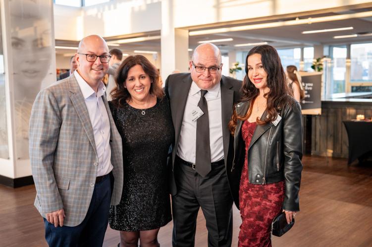 Group of people laughing and smiling at the camera.