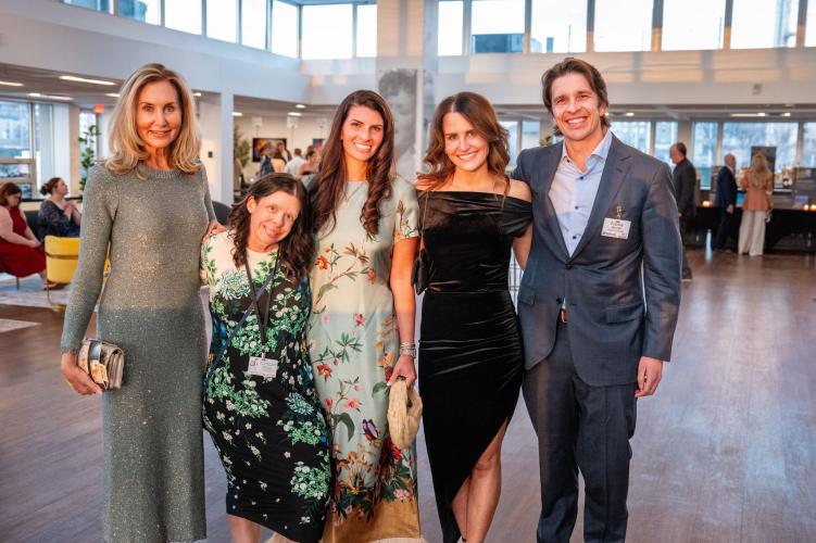 Group of people laughing and smiling at the camera.