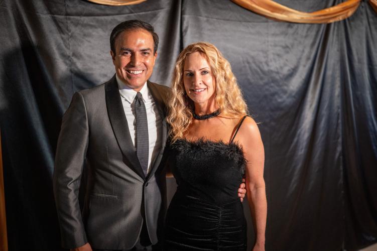 Man and woman taking a photo at the photo station at gala. 