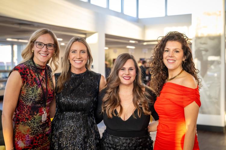Portrait of a group of women in lobby of gala event.
