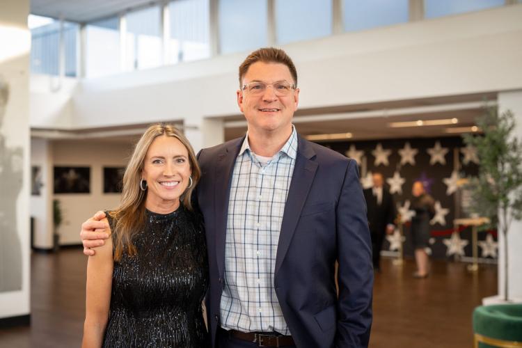 Man and woman in lobby of gala event.