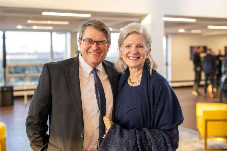 Man and woman in lobby of gala event.