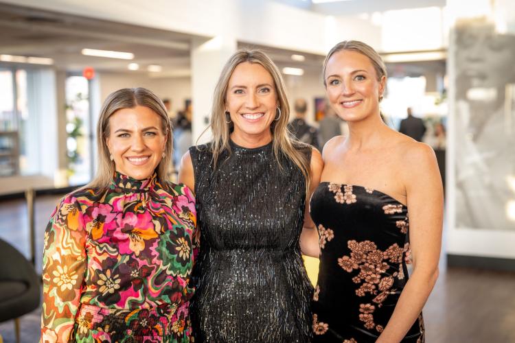 Portrait of three gala co-chairs in lobby of event. 