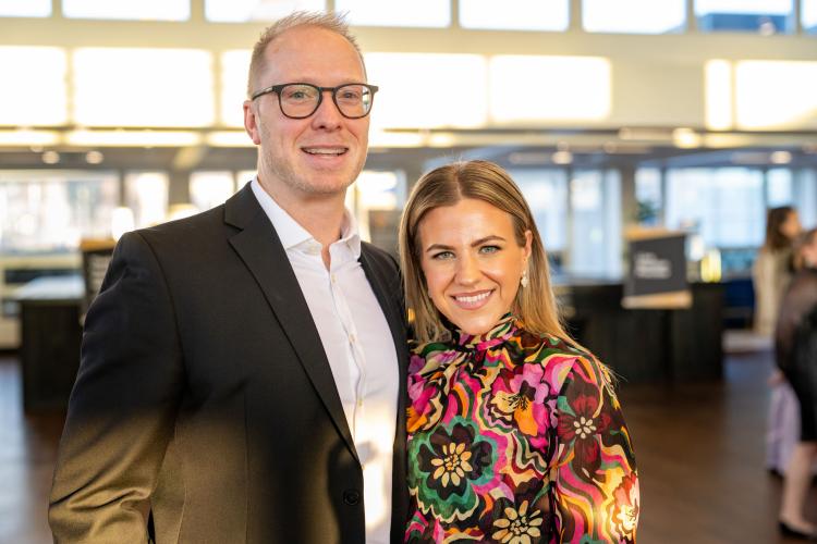 Man and woman in lobby of gala event.