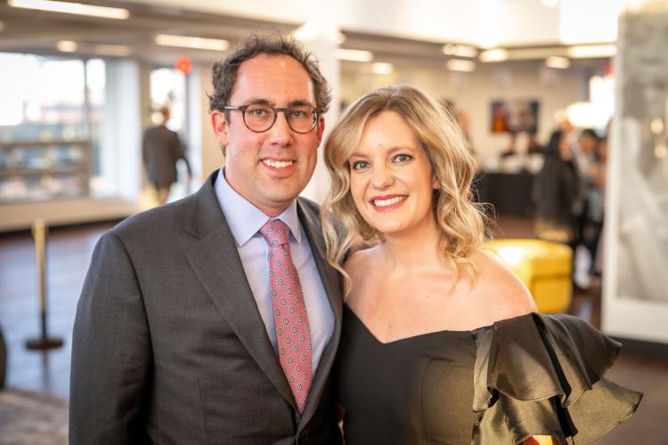 Man and woman in lobby of gala event.