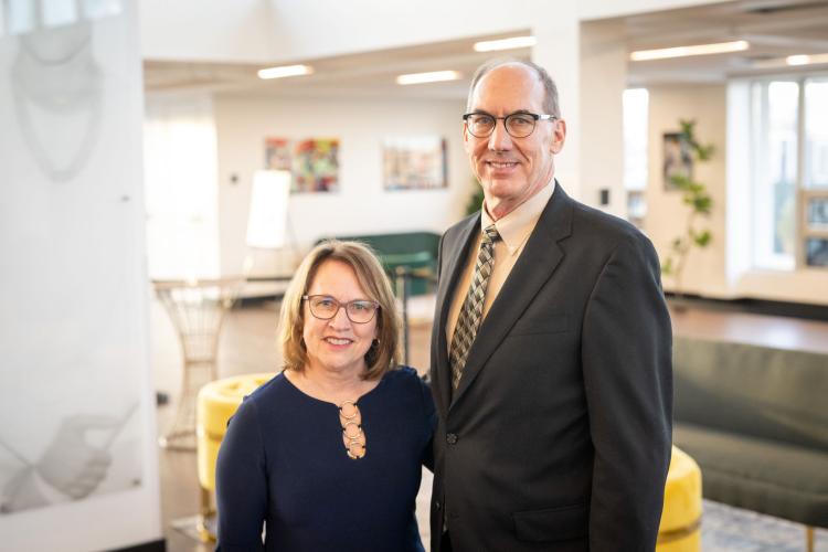 Man and woman in lobby of gala event.