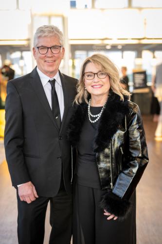 Man and woman in lobby of gala event.