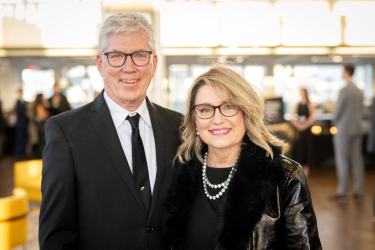 Man and woman in lobby of gala event.