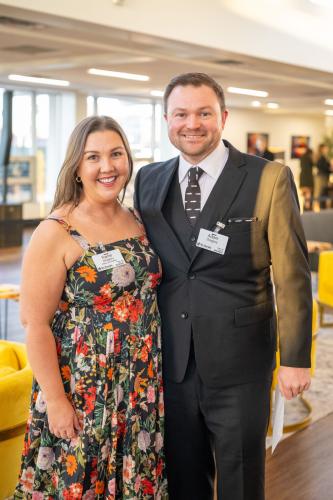 Man and woman in lobby of gala event.