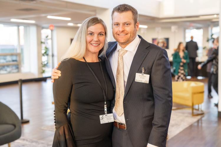 Man and woman in lobby of gala event.